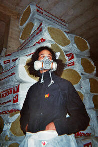 Pharoah standing in front of the pile of rockwool (insulation).